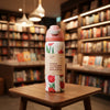 A reusable insulated water bottle with a pink flip-top lid and a white body printed with red tulips and the phrase 'Hi there, I'm insulated. And I have a built-in straw.