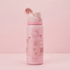 A pink water bottle with a Hello Kitty design, featuring a flip-top lid and printed cartoon graphics, set against a solid pink background.