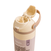 A close-up of an Owala water bottle with a beige and light pink design, showing the open flip-top lid and straw spout mechanism on a white background.